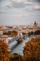 Chain bridge over the Danube river in Budapest. Hungary. Autumn cityscape with old buildings and opera domes