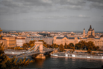 Chain bridge over the Danube river in Budapest. Hungary. Autumn cityscape with old buildings and opera domes