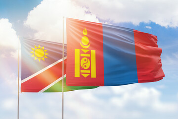 Sunny blue sky and flags of mongolia and namibia
