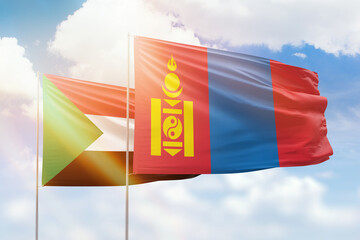 Sunny blue sky and flags of mongolia and sudan