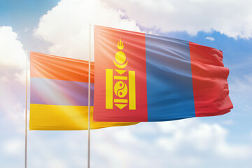 Sunny blue sky and flags of mongolia and armenia