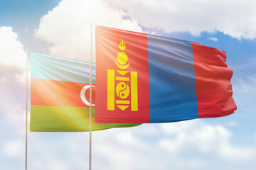 Sunny blue sky and flags of mongolia and azerbaijan