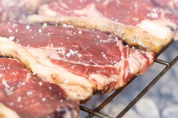 Obraz premium close-up of salt-baked cutlets cooking on the barbecue grill