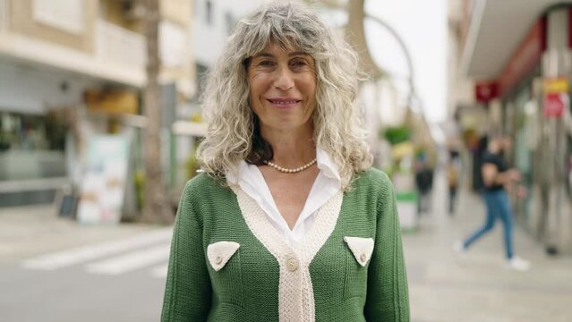 Middle age woman smiling confident standing at street