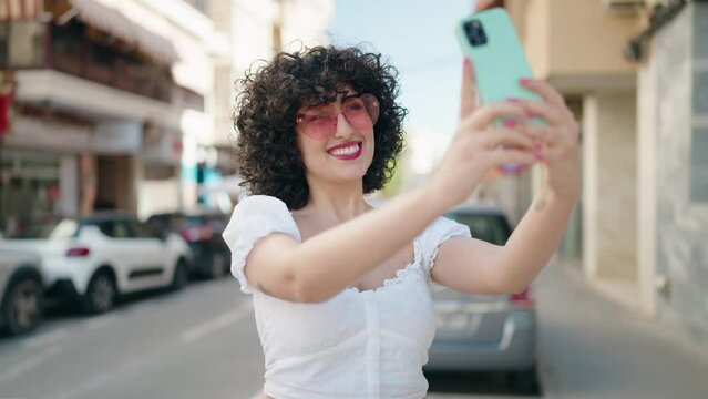 Young middle east woman smiling confident using smartphone at street