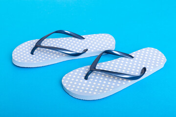 Beach accessories. Flip flops and starfish on colored background. Top view Mock up with copy space