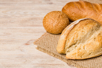 Homemade natural breads. Different kinds of fresh bread as background, perspective view with copy space