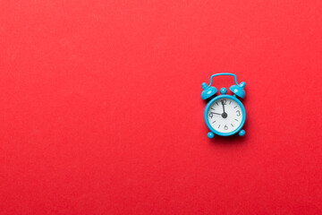 Alarm clock isolated on colored background with copy space top view