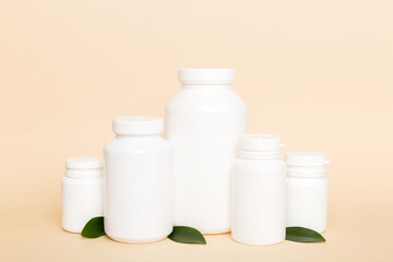 supplement pills with medicine bottle health care and medical top view. Vitamin tablets. Top view mockup bottle for pills and vitamins with green leaves, natural organic bio supplement, copy space