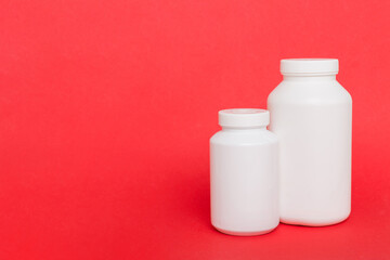 supplement pills with medicine bottle health care and medical top view. Vitamin tablets. Top view mockup bottle for pills and vitamins with green leaves, natural organic bio supplement, copy space