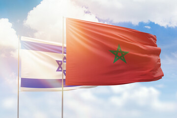 Sunny blue sky and flags of morocco and israel