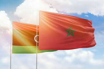 Sunny blue sky and flags of morocco and libya