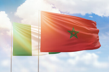 Sunny blue sky and flags of morocco and nigeria