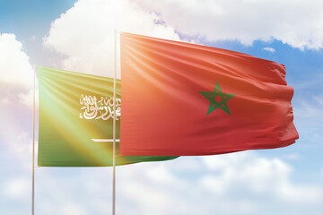 Sunny blue sky and flags of morocco and saudi arabia