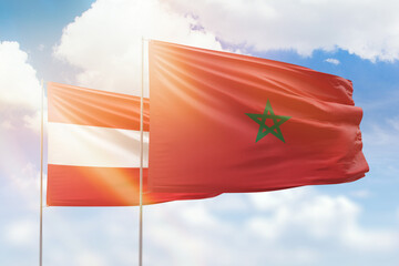 Sunny blue sky and flags of morocco and austria