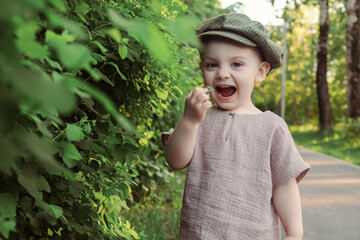 Cute funny playful toddler boy enjoying summer.
