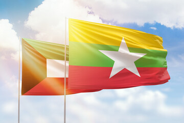 Sunny blue sky and flags of myanmar and kuwait