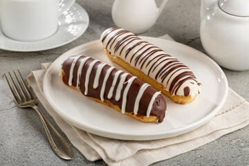 Eclair. Tasty chocolate eclair on the table.