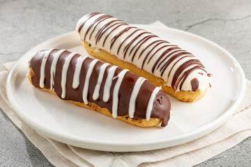 Eclair. Tasty chocolate eclair on the table.