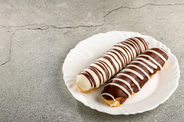 Eclair. Tasty chocolate eclair on the table.