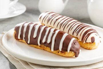 Eclair. Tasty chocolate eclair on the table.