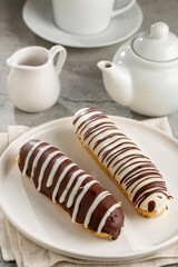 Eclair. Tasty chocolate eclair on the table.