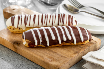 Eclair. Tasty chocolate eclair on the table.
