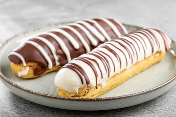 Eclair. Tasty chocolate eclair on the table.