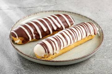 Eclair. Tasty chocolate eclair on the table.