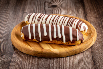 Eclair. Tasty chocolate eclair on the table.
