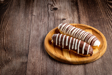 Eclair. Tasty chocolate eclair on the table.