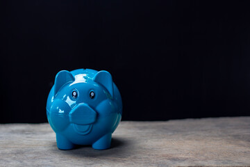 blue piggy bank with black background