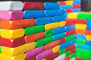 Children play colorful big toy blocks in kindergarten day care center playground, kids playing with various plastic mega construction blocks bricks