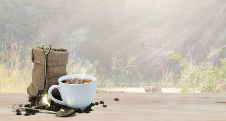 coffee cup and roasted beans in a bag on the table, backdrop of a mountains.