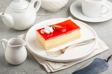 Slice of cheesecake with strawberry topping.