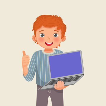 Happy little boy student holding laptop with blank screen giving thumb up