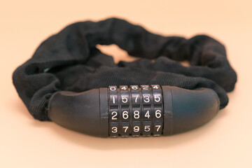 Chain lock for a bicycle with password and scratch protection on a yellow background. Steal. Biking. Travel. Secure. Object. Wheel. Locking. Cycling. Access. Coded. Close. Encrypt. Pass