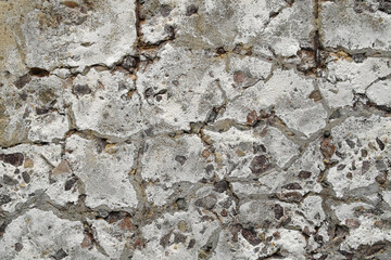 The texture of an old concrete slab crumbled from time to iron reinforcement.