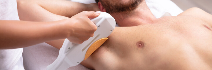 Young Man Having Underarm Laser Hair Removal Treatment