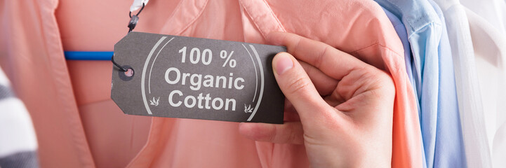 Woman Holding Label Showing 100 Percent Organic Cotton