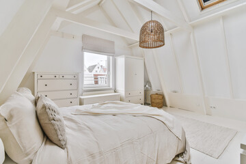 Interior of contemporary bedroom with white walls in attic of house