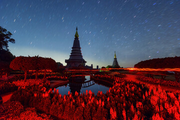 Star trails moving over a sacred temple at Doi Inthanon National Park, Chiang Mai, Thailand. 