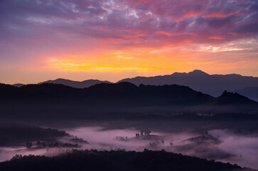 Naklejka premium Aerial view Beautiful of morning scenery Golden light sunrise And the mist flows on high mountains, Baan Ja Bo, Mae Hong Son, Thailand.