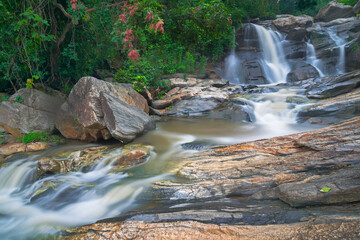 Beautiful Turga waterfall having full streams of water flowing downhill amongst stones , duriing...