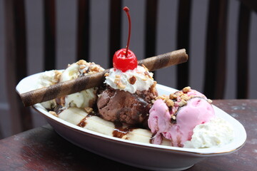 Banana split ice cream on wood table. Homemade Banana Split Sundae with Chocolate Vanilla.