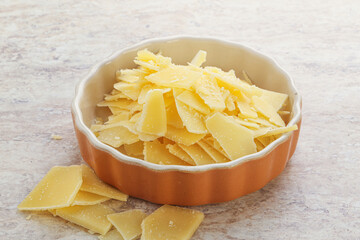 Sliced parmesan cheese heap in the bowl