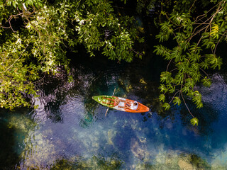 couple in a kayak in the jungle of Krabi Thailand, men and woman in kayak at a tropical jungle in...
