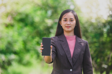 business woman Standing on the phone in the park beside the town