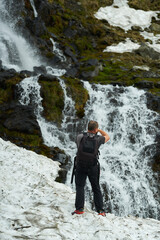 Man shooting a waterfall through snow