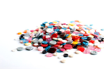 A pile of colorful buttons on a white background.